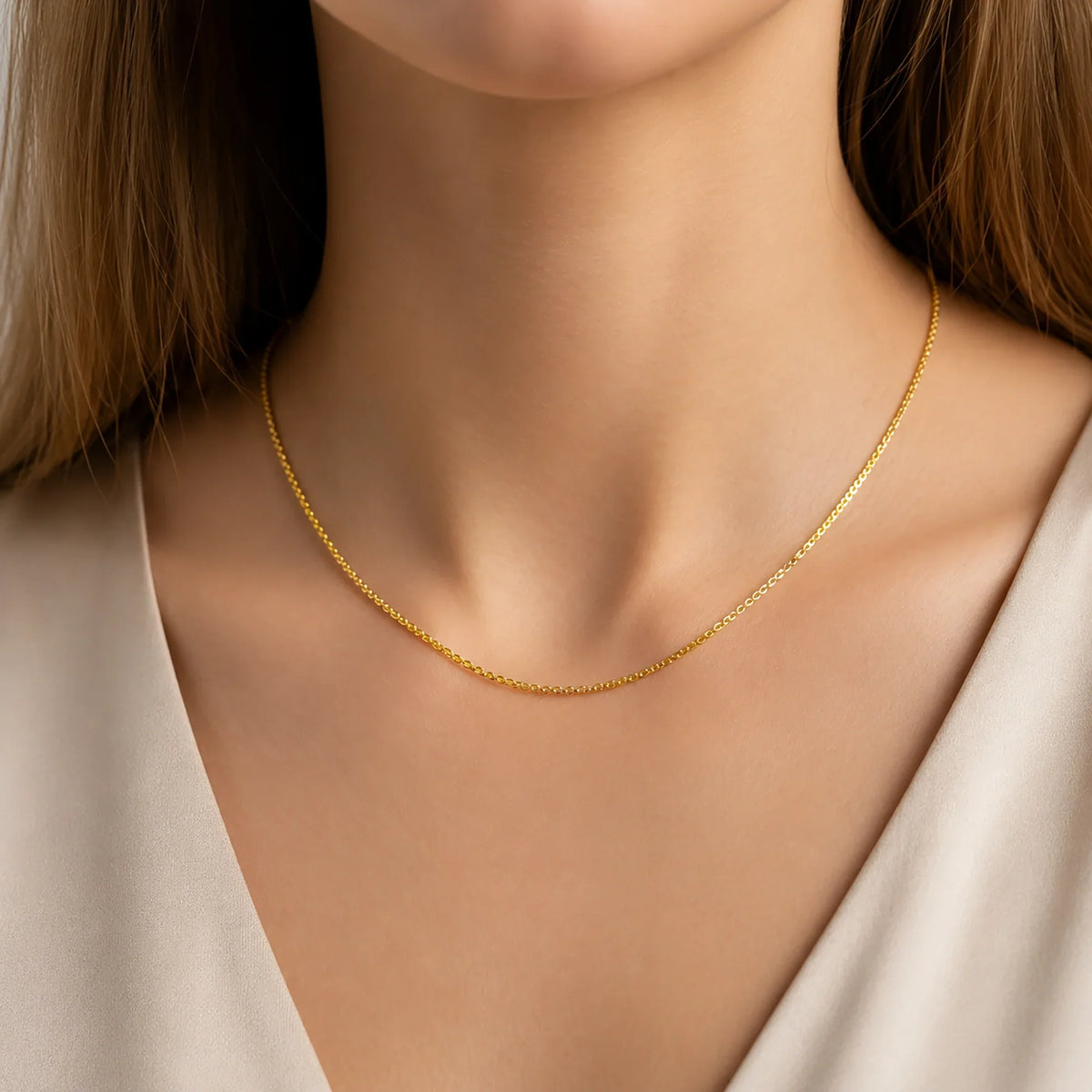 Woman wearing a Lucche solid 14K gold delicate chain necklace.