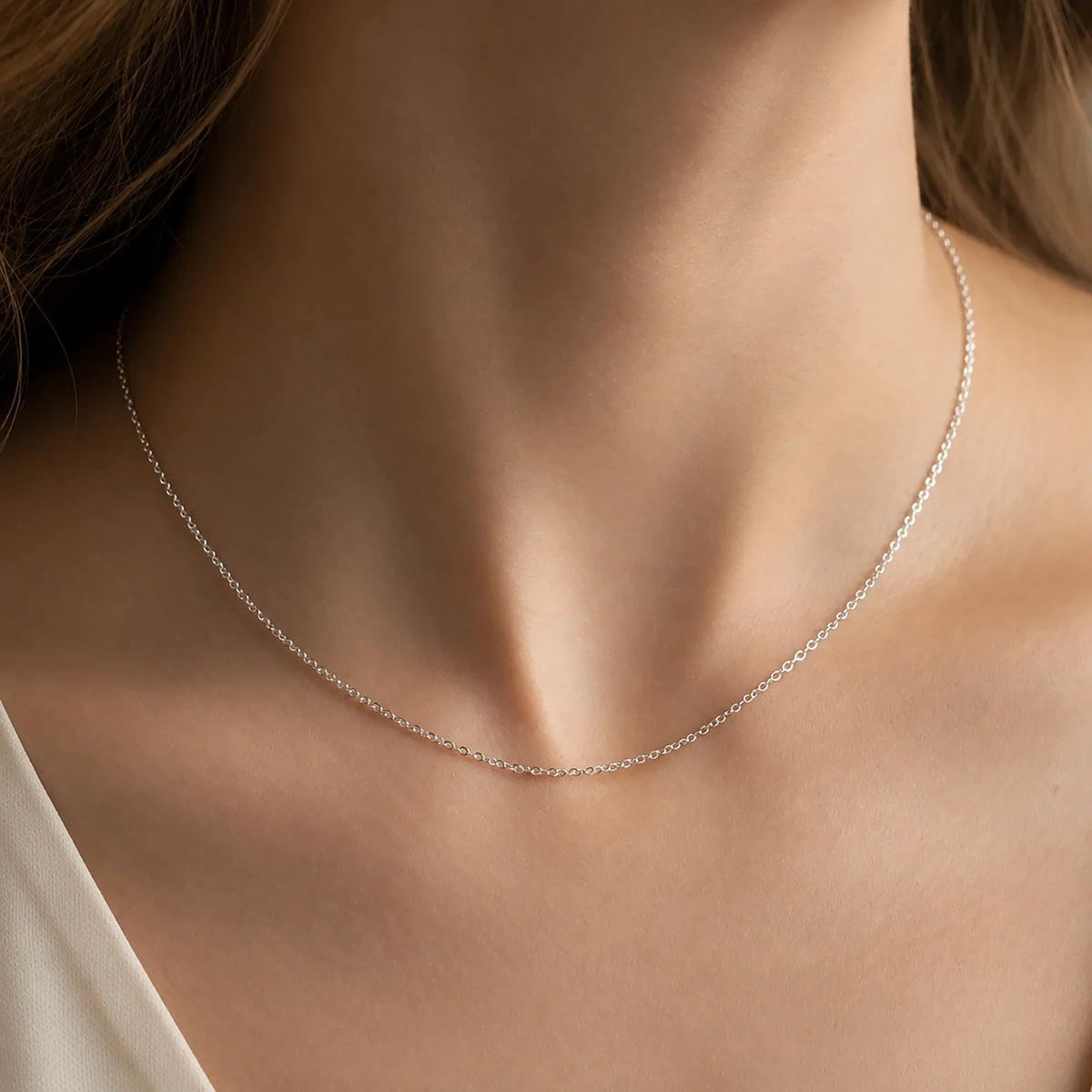 Woman wearing a Lucche 14K solid white gold fine chain necklace.