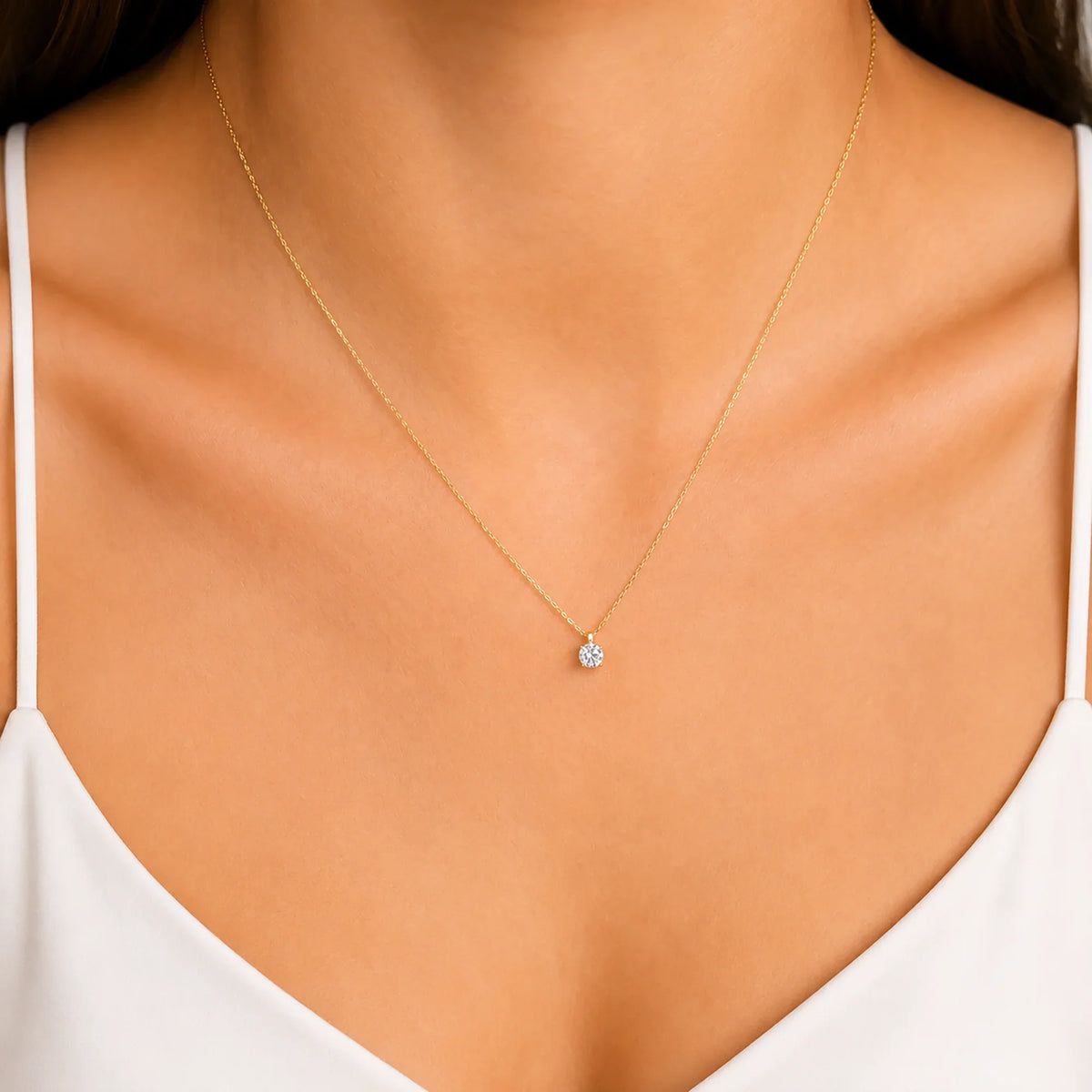 Woman wearing a Lucche 14K solid gold necklace with a single diamond-style pendant