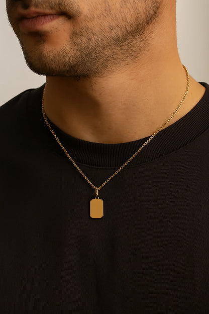 Man wearing a LuccheGold 14K gold personalized rectangle tag pendant on a gold chain