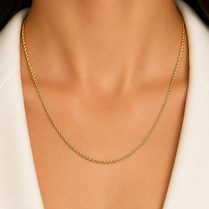 Woman wearing a Lucche 14K gold rope chain twisted necklace.
